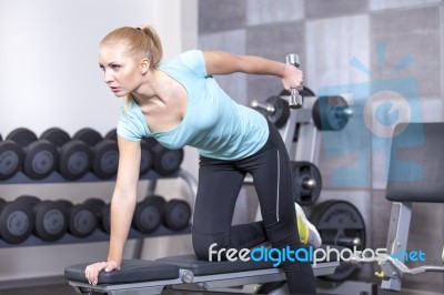 Attractive Blond Sporty Girl Doing Triceps Training With A Dumbb… Stock Photo