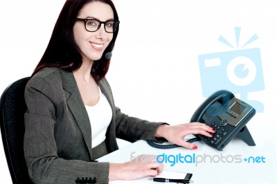 Attractive Female Executive Dialing Clients Number Stock Photo