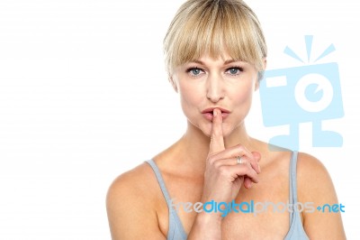 Attractive Middle Aged Woman Gesturing Silence Stock Photo