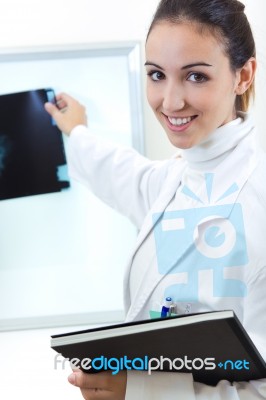 Attractive Young Female Doctor Examining X-ray Results Stock Photo