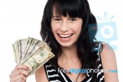 Attractive Young Girl Holding Currency Fan Stock Photo