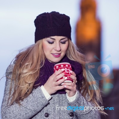 Attractive Young Stylish Blonde Girl Drinks Hot Drink From A Mug… Stock Photo