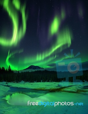 Aurora Borealis Over Frozen Lake Stock Photo