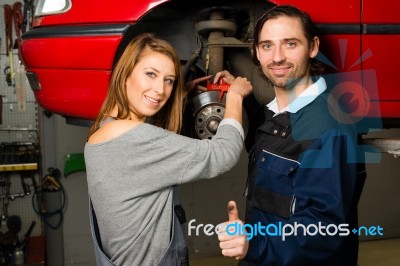 Auto Mechanic And Female Trainee In Garage Stock Photo