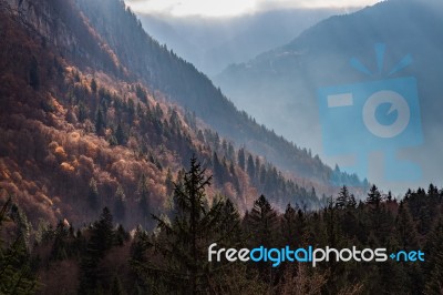Autumn Valley In The Alps With Sunlight Breaking Through Stock Photo