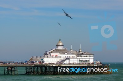 Avro Lancaster And Spitfire Mk1 Flying Over Eastbourne Pier Stock Photo