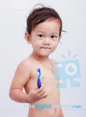 Baby And Toothbrush Stock Photo