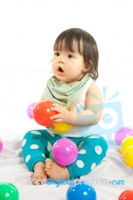 Baby Girl Is Playing Ball On White Background Stock Photo