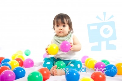 Baby Girl Is Playing Ball On White Background Stock Photo