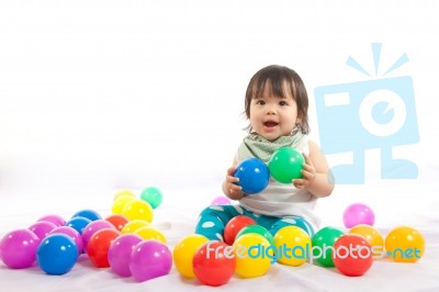 Baby Girl Is Playing Ball On White Background Stock Photo
