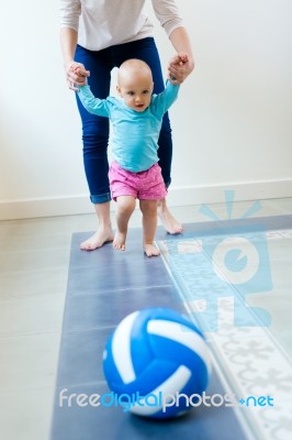 Baby Girl Learning To Walk At Home Stock Photo