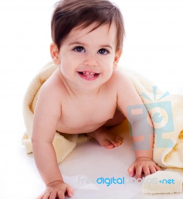 Baby Showing Its Teeth Under Yellow Towel Stock Photo