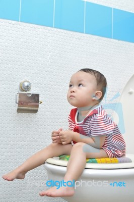 Baby Sitting On Toilet Stock Photo