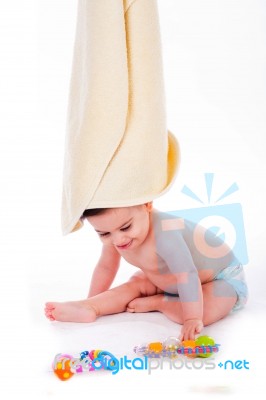 Baby With Towel On Is Head While Playing Toys Stock Photo