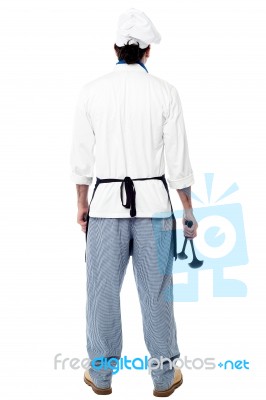 Back Pose Of A Male Chef In Uniform Stock Photo
