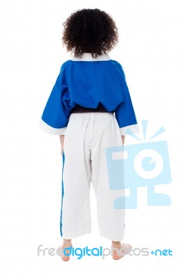 Back Pose Of A Small Girl In Karate Uniform Stock Photo