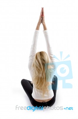 Back Pose Of Woman Doing Yoga Stock Photo