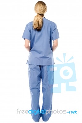 Back Pose Of Young Female Doctor Stock Photo