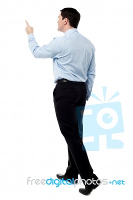 Back View Of A Middle Aged Man Pointing Finger Stock Photo