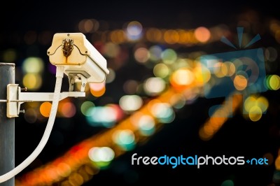 Back View Of Cctv Camera With Night City Bokeh Stock Photo