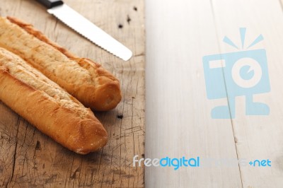 Baguette Bread On Rustic White Wooden Background Stock Photo