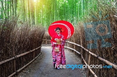 Bamboo Forest. Asian Woman Wearing Japanese Traditional Kimono At Bamboo Forest In Kyoto, Japan Stock Photo