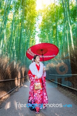 Bamboo Forest. Asian Woman Wearing Japanese Traditional Kimono At Bamboo Forest In Kyoto, Japan Stock Photo