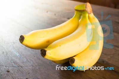 Banana On Brown Wooden Background Stock Photo
