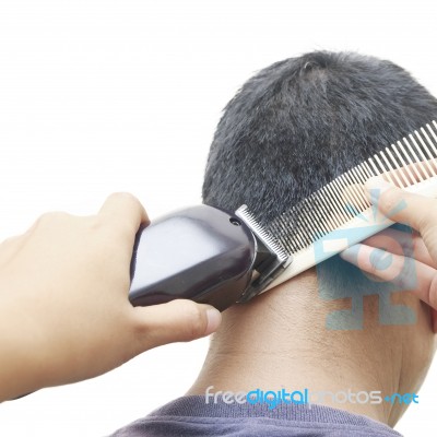 Barber Cutting Hair With Clipper Stock Photo