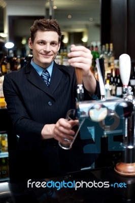 Bartender holding glass Stock Photo