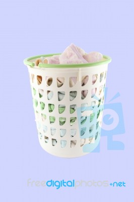 Basket Of Cloth Before Washing On Blue Background Stock Photo