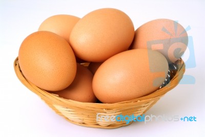 Basket Of Straw With Eggs In White  Stock Photo