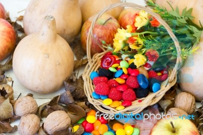Basket With Halloween Candy And Autumn Decorations Stock Photo