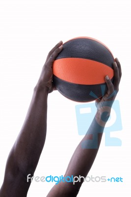 Basketball With Hands Of Man On A White Background Stock Photo