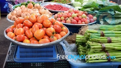 Baskets Of Tomatoes And Vegetable At A Farmer's Market Stock Photo