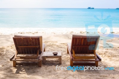 Beach Chairs On The White Sand Beach With  Blue Sky And Sun Stock Photo
