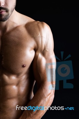 Beautiful And Muscular Man In Dark Background Stock Photo