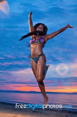 Beautiful Black African American Woman Jumping On The Beach At S… Stock Photo