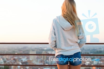 Beautiful Blonde Stands On The Edge Of The Roof Stock Photo