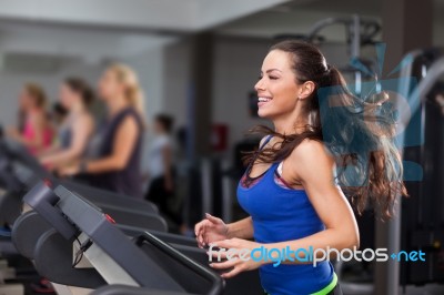 Beautiful Brunette On A Treadmill Stock Photo