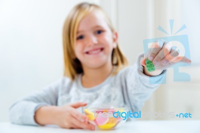 Beautiful Child Eating Sweets At Home Stock Photo