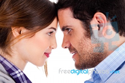 Beautiful Couple Smiling And Facing Each Other Stock Photo