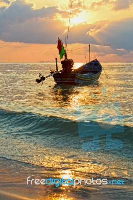 Beautiful  Fishing Boat Floating With Golden Sunrise Light Backg… Stock Photo