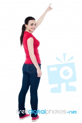 Beautiful Girl Is Pointing Up With Her Hand Stock Photo