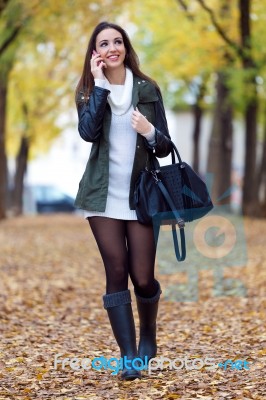 Beautiful Girl Talking On Phone In Autumn Stock Photo