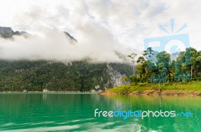 Beautiful High Mountains And Green Lake Stock Photo