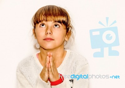 Beautiful Little Girl Praying And Looking Up, Isolated On White Stock Photo