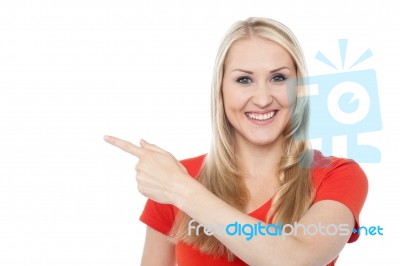Beautiful Smiling Woman Pointing Away Stock Photo