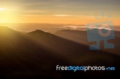 Beautiful Sun Rise On Top Mountain With Sun Ray Warm Tone Stock Photo
