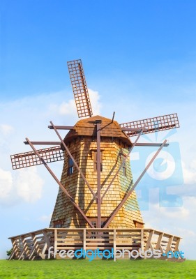Beautiful Wind Mills On Green Grass Field Against Natural Blue S… Stock Photo